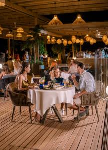a group of people sitting at a table in a restaurant at Liu Resorts in Side