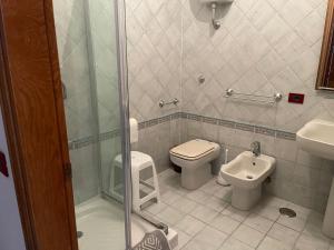 a bathroom with a shower and a toilet and a sink at Hotel Lo Smeraldo in Ventotene