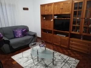 a living room with a couch and a glass coffee table at Casa da Vista Rio in Amora