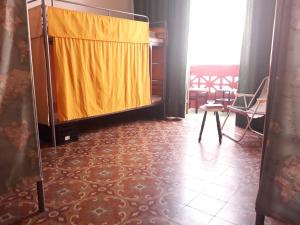 a room with a bed, chair, and table in it at Stardust House Vegueta in Las Palmas de Gran Canaria
