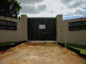 a gate to a game farm with two signs on it at Simbonga Game Reserve & Sanctuary in Thornhill