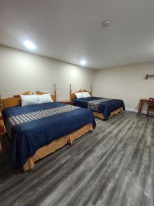 A bed or beds in a room at Majestic Inn & Suites