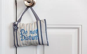 a do not disturb bag hanging on a door at The Roundhouse in Weymouth