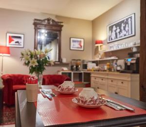 a kitchen with a table with two plates of food on it at LOGIS Hôtel Du Théâtre in Tours