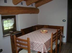 a dining room with a table with a bowl on it at La Petite Maison in Arvier