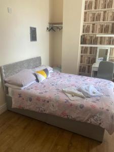 a bedroom with a bed with a purple comforter at The Winter Garden Suites in Blackpool