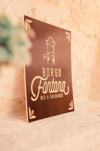 a sign for a baroco fanta sign on a wall at Borgo Fontana B&B in Bari