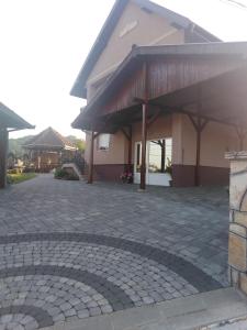 a house with a brick driveway in front of it at BLAGOJEVIĆ in Guča