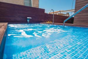 uma piscina com água azul num edifício em Holiday Rentals Tempa Museo em Sevilha