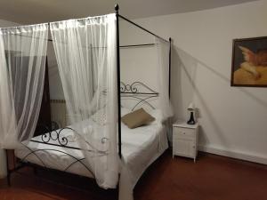 a bedroom with a bed with a canopy at Relax nel Borgo, La Fontana in Campagnano di Roma +3 photos