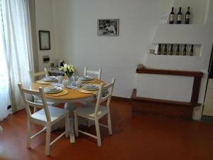 a dining room with a table and chairs and wine bottles at Relax nel Borgo, La Fontana in Campagnano di Roma