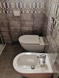 a bathroom with a toilet and a sink at Annina Home in Paestum +26 photos