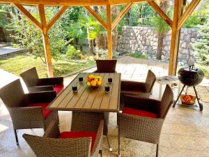 a wooden table and chairs on a patio at Holiday Home "Opatija" in Opatija