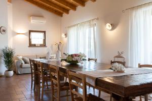 a kitchen and dining room with a wooden table and chairs at Agriturismo Bressani in Nimis