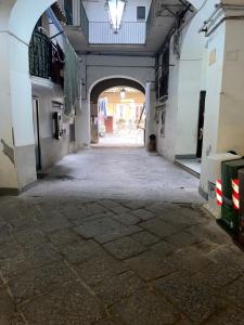 an empty alley with an archway in a building at B&B House S. Ferdinando in Naples