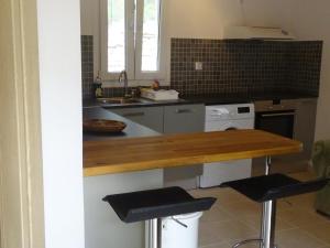 a kitchen with a counter and two stools at Villa Avlaki in Vlikhon