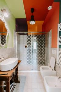a bathroom with a sink and a shower and a toilet at La Cascina // Valfaccenda in Canale