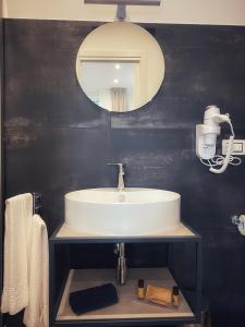 a bathroom with a sink and a mirror at Lumarooms B&B in Reggio Calabria