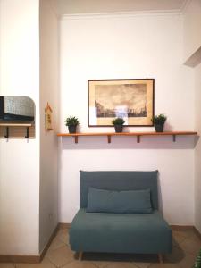 a couch in a room with a shelf on the wall at Appartamento Jungle Beach in Lido di Ostia
