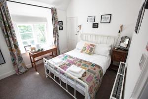 a small bedroom with a bed and a window at Old School Wolverton in Milton Keynes