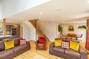 a living room with a couch and chairs and a table at Monarch Lodge 13 with Hot Tub in Belladrum