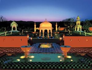 a large building with a large clock on top of it at The Oberoi Rajvilas Jaipur in Jaipur