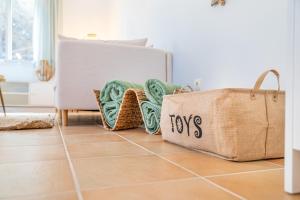 a room with a couch and a bag on the floor at Villa Cala Mesquida in Cala Mesquida