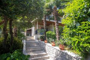 a stone staircase leading to a house with plants at Apartment Doris in Opatija