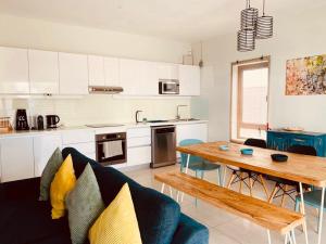 a living room with a couch and a wooden table at Beachcove Apartment 2 in Pereybere