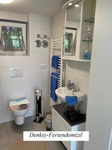 a small bathroom with a sink and a toilet at Denkys-Ferienwohnung in Maulburg