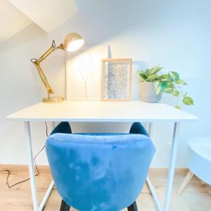 a white desk with a blue chair under it at AeroHome - Appart Confort - Aeroport d Orly à proximité - Parking in Athis-Mons