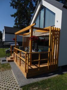 a house with a large deck on the side of it at Dom Omega in Ustka