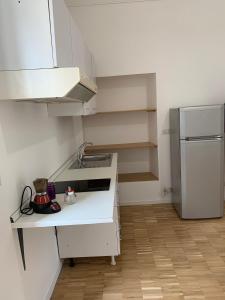 a kitchen with a white counter and a refrigerator at La Casa del Dottore in Rapolla