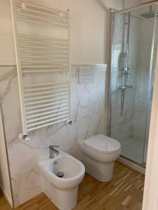 a bathroom with a toilet and a shower and a sink at La Casa del Dottore in Rapolla