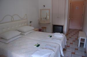 a bedroom with a bed with two towels on it at Hotel Villa Marie in Syvota +25 photos