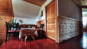 a dining room with a table and chairs and a door at Woden apartment in Žabljak