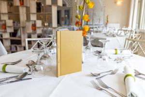 a table with a vase with yellow flowers on it at Park Manor Hotel in Scarborough