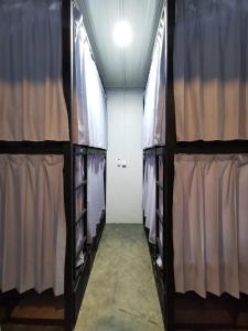 a walk in closet with racks of clothes at Lala Hostel in Banda Aceh