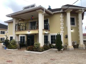 a large yellow building with a balcony at FOKUZZY LODGE in Accra