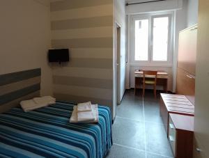 Ένα ή περισσότερα κρεβάτια σε δωμάτιο στο Hotel Mignon Posta
