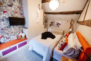 a small room with a bed and a tv at Oh So Snug in Whalley