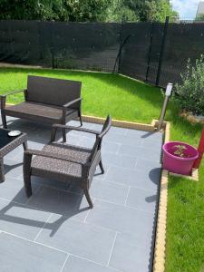 a patio with two chairs and a table and a bench at Maison Le Franc Palais in Joue-les-Tours