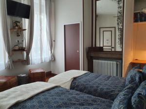 Кровать или кровати в номере B & B Les Secrets des Loges