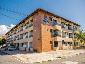 a large apartment building on the side of a street at Recanto da Orla in Aracaju