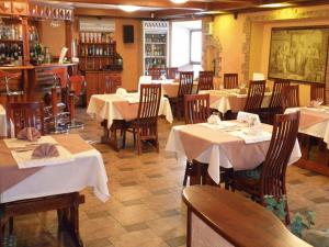 a restaurant with tables and chairs with white table cloth at Pallada Hotel in Novokuznetsk