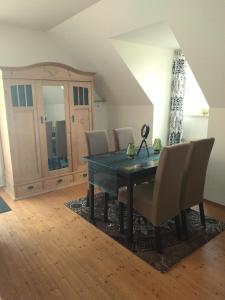 a dining room with a table and chairs at Jenny's Ferienwohnung in Monschau +12 photos