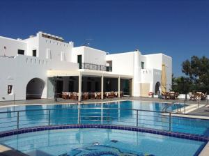 a large swimming pool in front of a white building at Astir Of Naxos in Naxos Chora