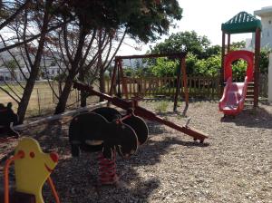 a playground with a slide and a swing set at Astir Of Naxos in Naxos Chora