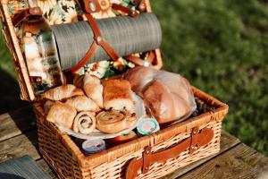 a basket filled with bread and pastries on a table at Slapen tussen de paarden in Essen