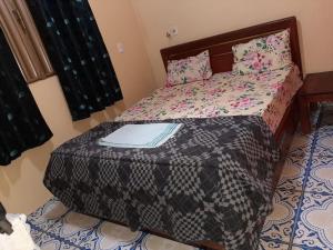 a bedroom with a bed with a laptop on it at RECANTO DO SABIÁ in Carolina +38 photos